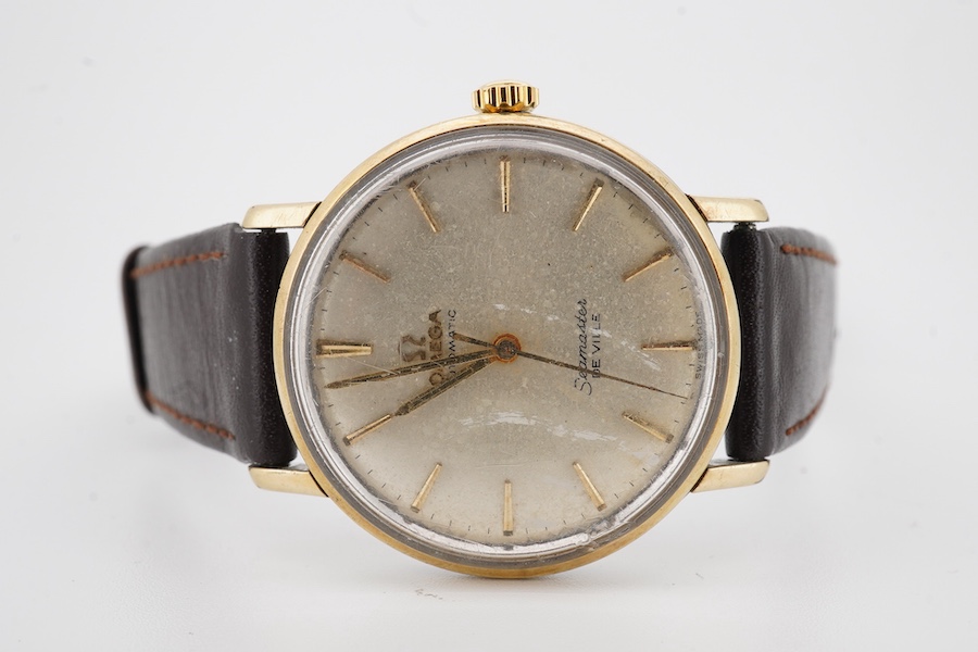 A gentleman's 1960's? steel and gold plated Omega Seamaster De Ville automatic wrist watch, with baton numerals, case diameter 35mm, on an associated leather strap, no box or papers.